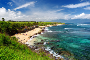 Obraz premium Famous Hookipa beach, popular surfing spot filled with a white sand beach, picnic areas and pavilions. Maui, Hawaii.