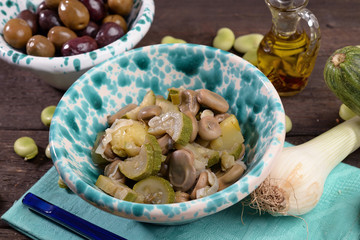 Bowl with fave in wet with onion and oregano and zucchini
