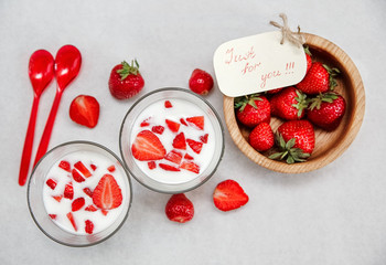 Glasses of Yogurt,Red Fresh Strawberries.Wooden Plate,Wish Card on the White Paper.Breakfast Organic Healthy Tasty Food.