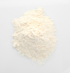 Heap of flour on white background, closeup