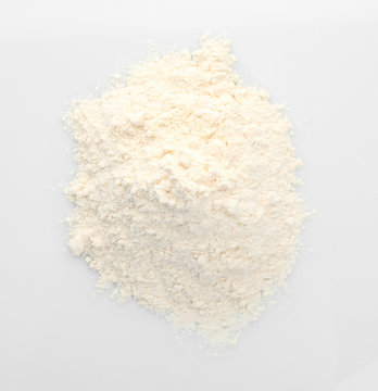 Heap of flour on white background, closeup