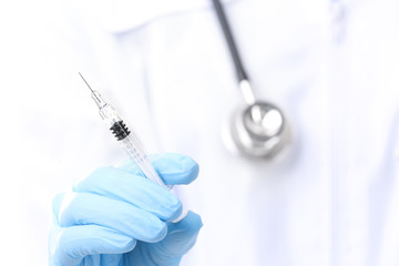 Doctor with syringe, closeup