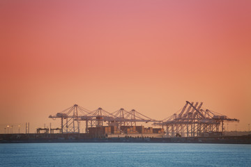 Crane bridge loading containers on bulk carrier