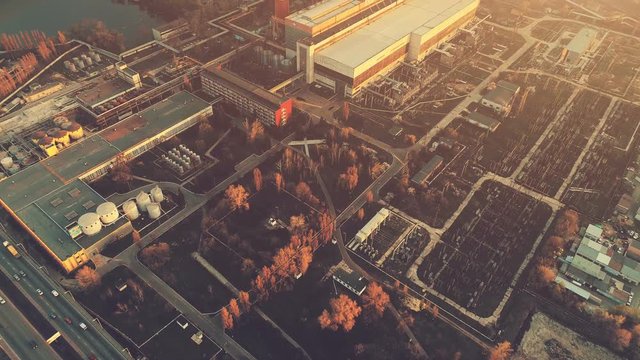 Aerial Drone Flight Footage over industrial zone of Kiev, Ukraine. Urban buildings, factory, power plant. Top view. Instagram vintage filter toning. Abstract futuristic cityscape in sunset soft light