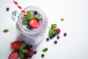 Berry milkshake on white.
