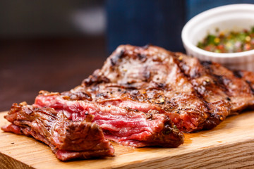 Beef steak rare sauced with herbs, pepper and pine nuts.