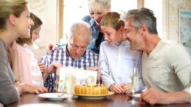 Family celebrating grandfather birthday together