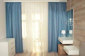 Interior of modern apartment with window and beautiful curtains
