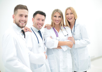 Happy and confident team of doctors posing on camera