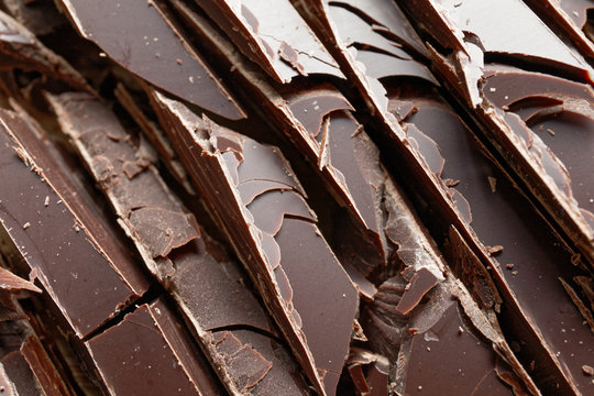 Close up of fine chocolate chopped by hand, sliced off the block with a knife. - Powered by Adobe