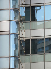 office business building windows with reflected clouds