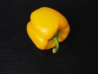 Yellow bell pepper on black backgroumd