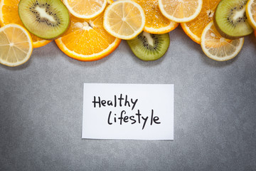 Healthy lifestyle words with fruits on gray background