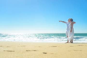 Young romantic couple hugging on the beach