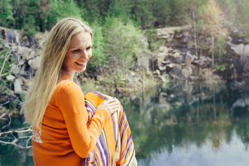 woman enjoying blue lake water on the high cliff in summer