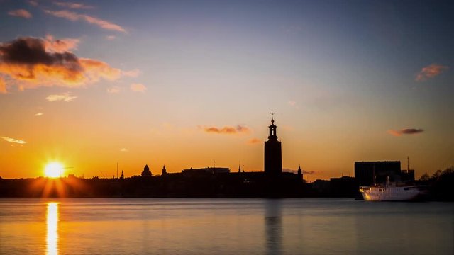 Time lapse of bay Riddarfjarden and The City Hall of Stockholm at sunset