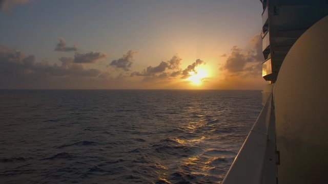 Vibrant Sunset from a Cruise Ship at Sea Sailing on Calm Idyllic Ocean Waters of the Caribbean