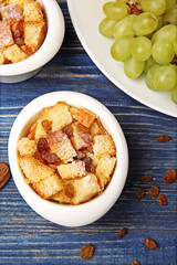 Delicious bread pudding with fruits on table