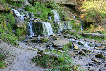 Fototapeta na wymiar Water streams and cascade of the waterfalls