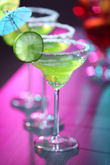 Glass of tasty cocktail on bar counter