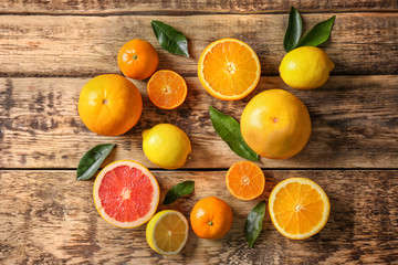 Obraz na płótnie Canvas Fresh assorted citrus fruits on wooden background