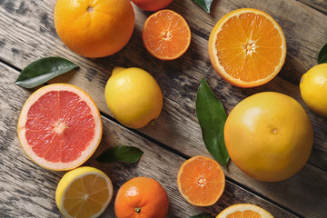 Fototapeta na wymiar Fresh assorted citrus fruits on wooden background