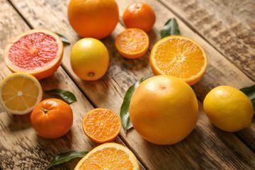 Fresh assorted citrus fruits on wooden background