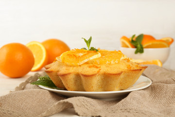 Plate with delicious citrus cake on table