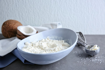 Bowl with fresh coconut ice cream on table