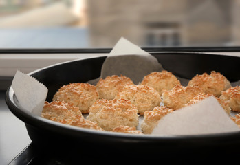 Baking tray with delicious coconut macaroons on table