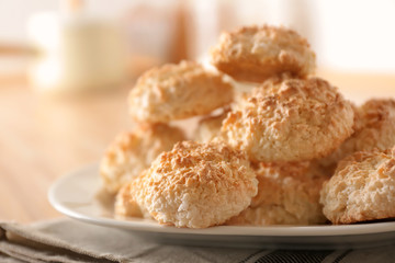 Plate with delicious coconut macaroons on table
