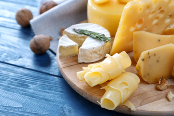 Beautiful composition with variety of cheese on wooden background