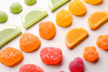 Fototapeta na wymiar Composition of tasty jelly candies on light background