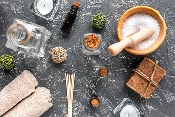 bathroom salt and natural soap for spa on dark background top view