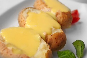 Baked potato with cheese sauce, closeup