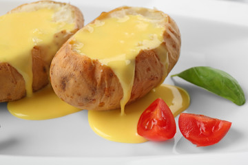 Baked potato with cheese sauce, closeup
