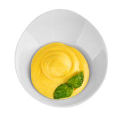 Bowl with cheese sauce on white background