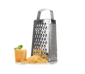 Metal grater and piece of cheese on white background