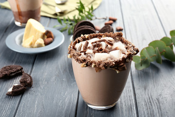 Cup of tasty cocoa drink with marshmallow on wooden table