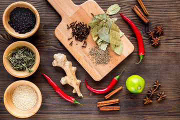 Dry colorful spices, chili pepper on kitchen wooden table background top view