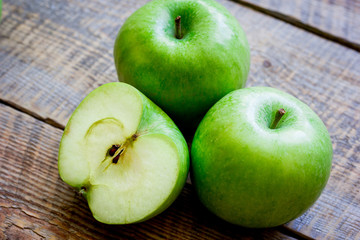 summer food with green apples on wooden background