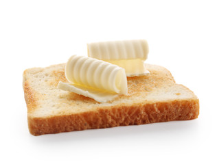 Slice of bread with butter curls on white background