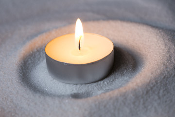 Candle on sand