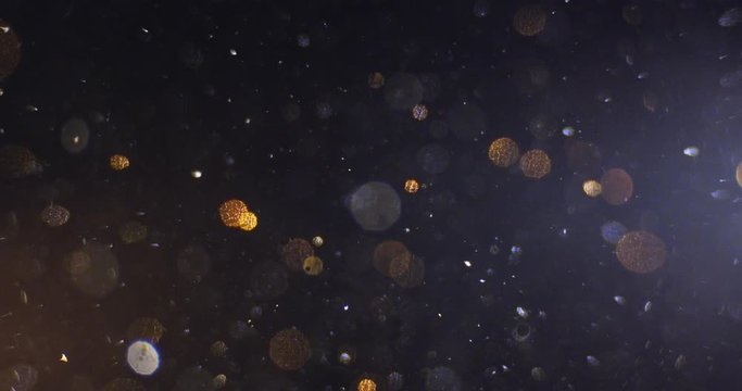 Abstract models mountains and planet made of golden plasticine, immersed in liquid. Closeup. 4K. Camera RED.
