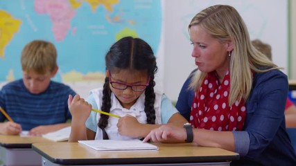 Teacher and student in school classroom