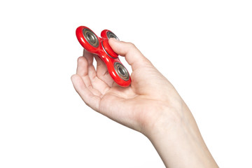 Boy holding popular fidget spinner toy on a white background.