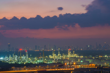 Oil refinery industry with cityscape twilight sky background, Bangkok, Thailand.