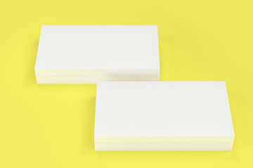 White blank business cards mock-up on yellow background