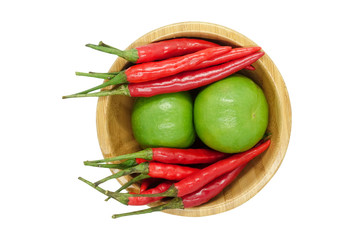 Red chili pepper and lime in wooden bowl isolated on white