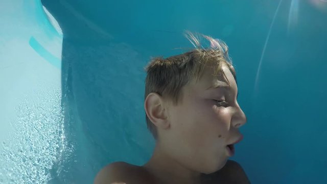 POV shot of boy going down waterslide